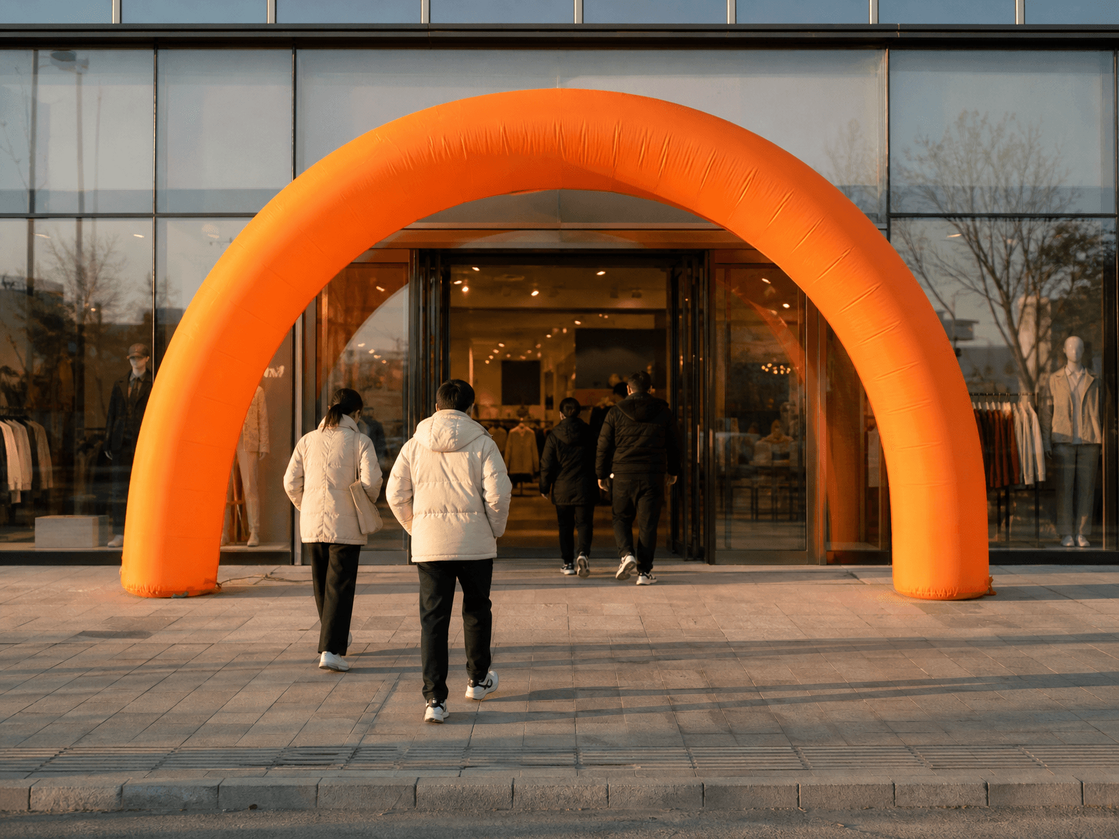 Inflatable arch framing a new store entrance on opening morning with a clear, accessible doorway
