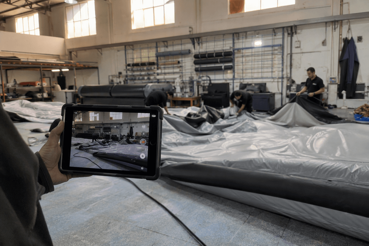Factory-direct verification scene with a buyer checking the production floor on a tablet