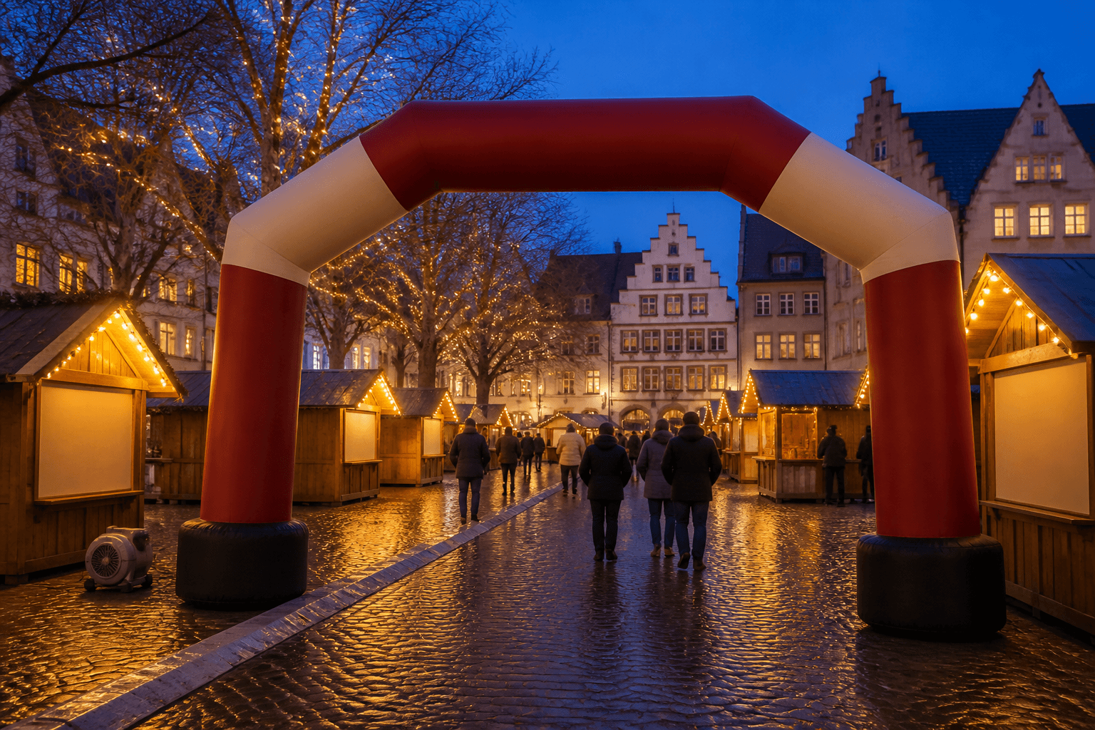 Red and cream inflatable arch at a blue-hour Christmas market