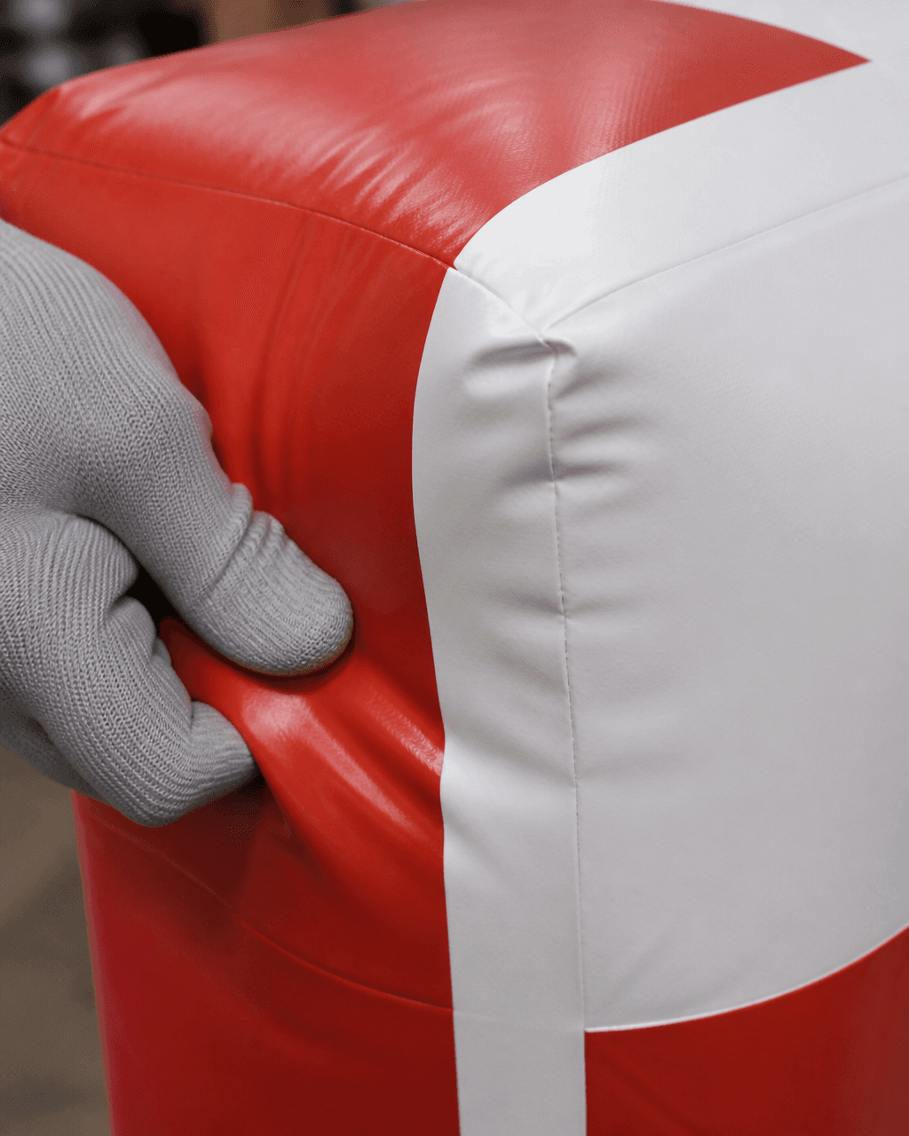 Close-up of printed surface and seam construction on a red and white inflatable Christmas gift box