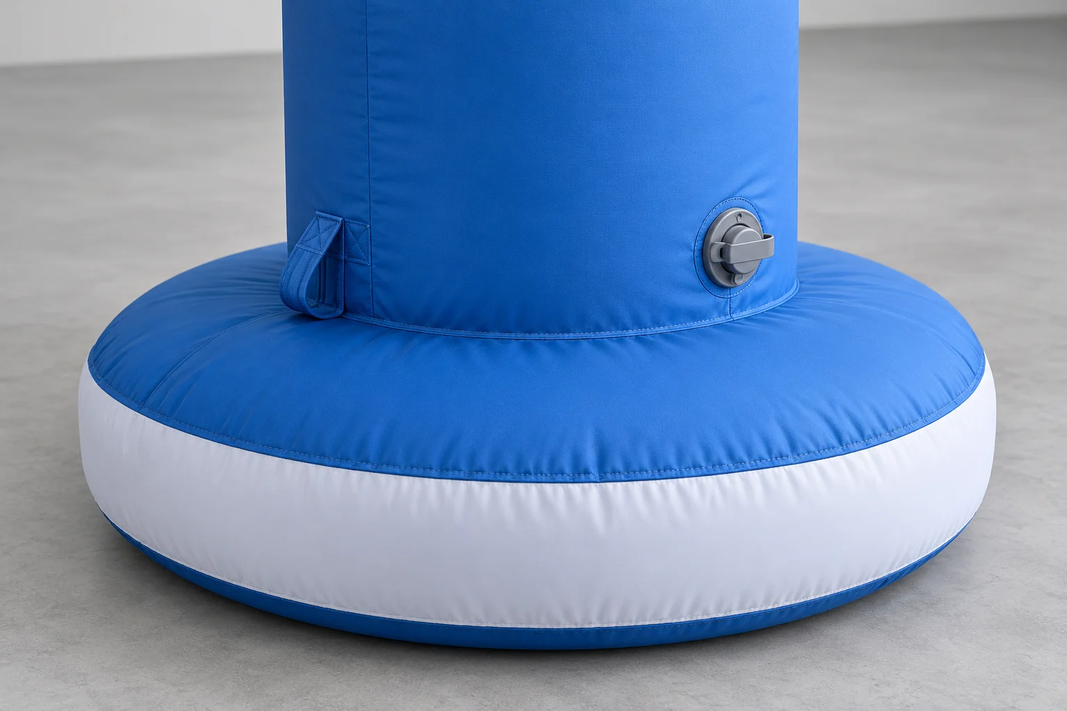 AI-generated close-up of a blue inflatable column base, fabric seam and capped valve