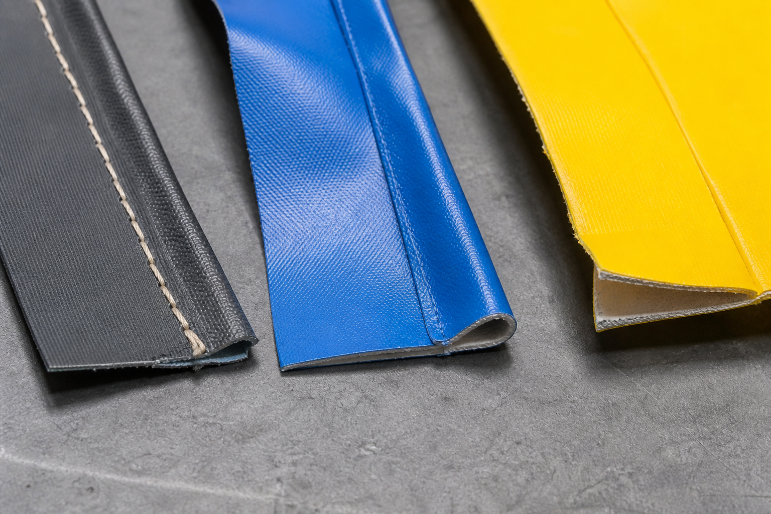 Macro view of three seam samples: stitched fabric, welded PVC and adhesive-bonded PVC