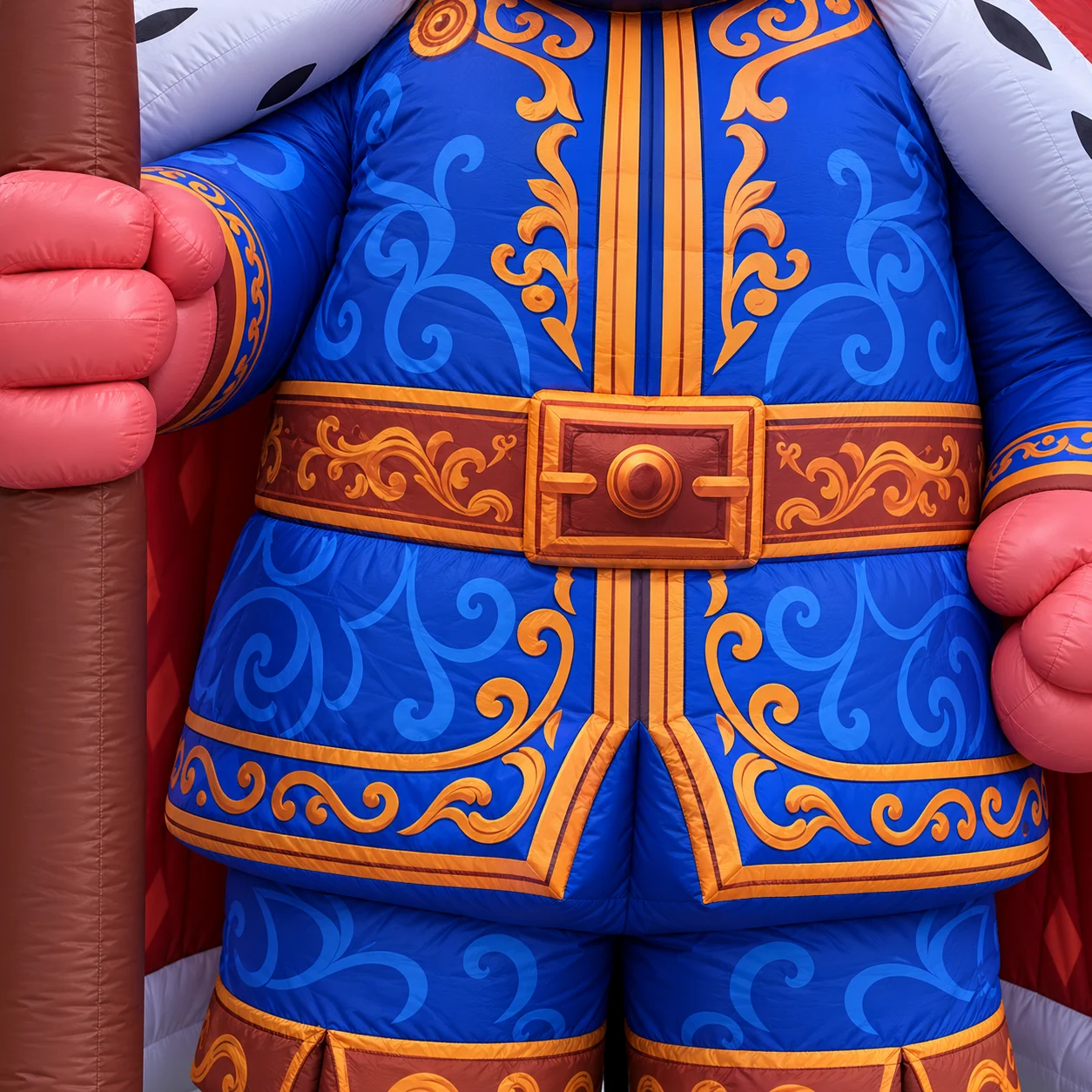 King mascot blue and gold tunic artwork with hand and scepter detail