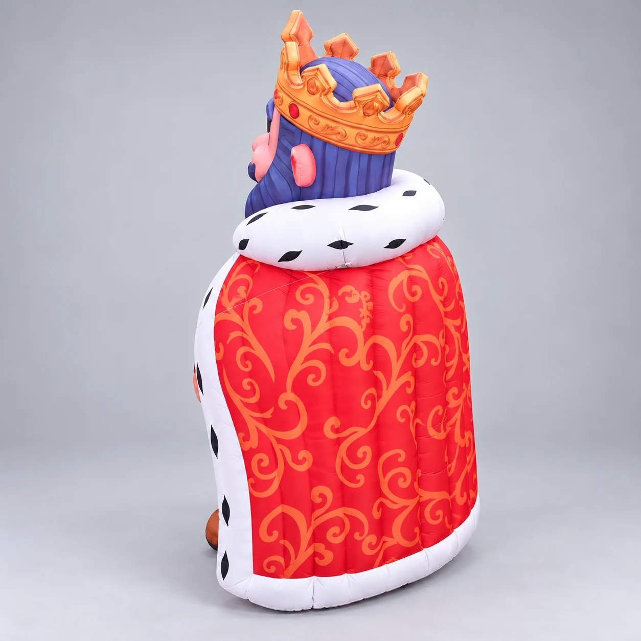 Rear view of the king inflatable showing the patterned red cape and crown